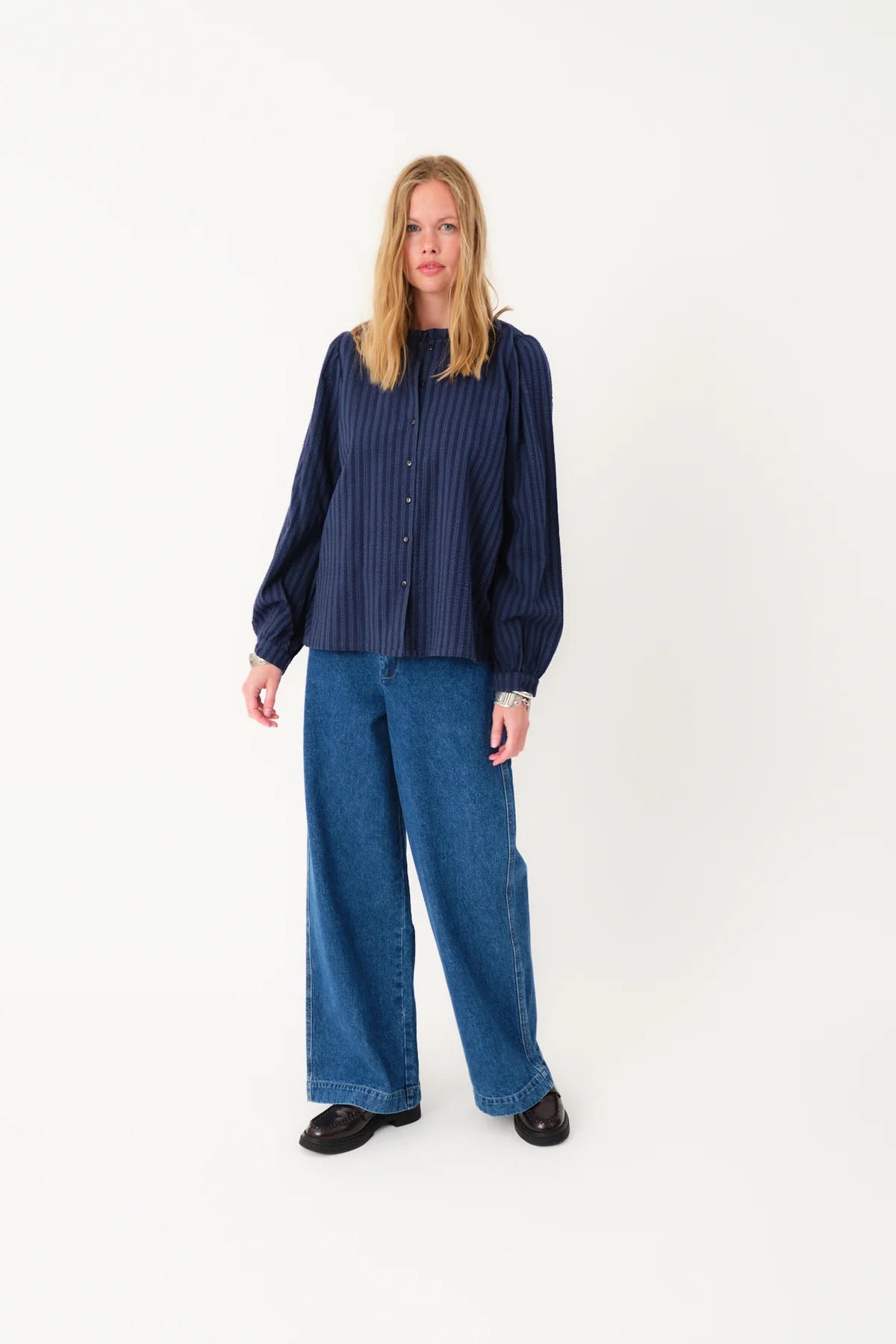Blue striped blouse on a light gray background