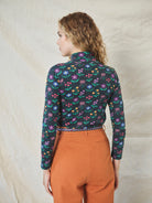 A long sleeve printed roll neck t-shirt with a turtle pattern in multicolor on a black background, made from organic cotton.