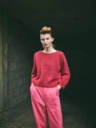 A cropped, bracelet sleeve, round neck red mohair jumper.