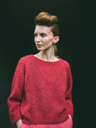 A cropped, bracelet sleeve, round neck red mohair jumper.