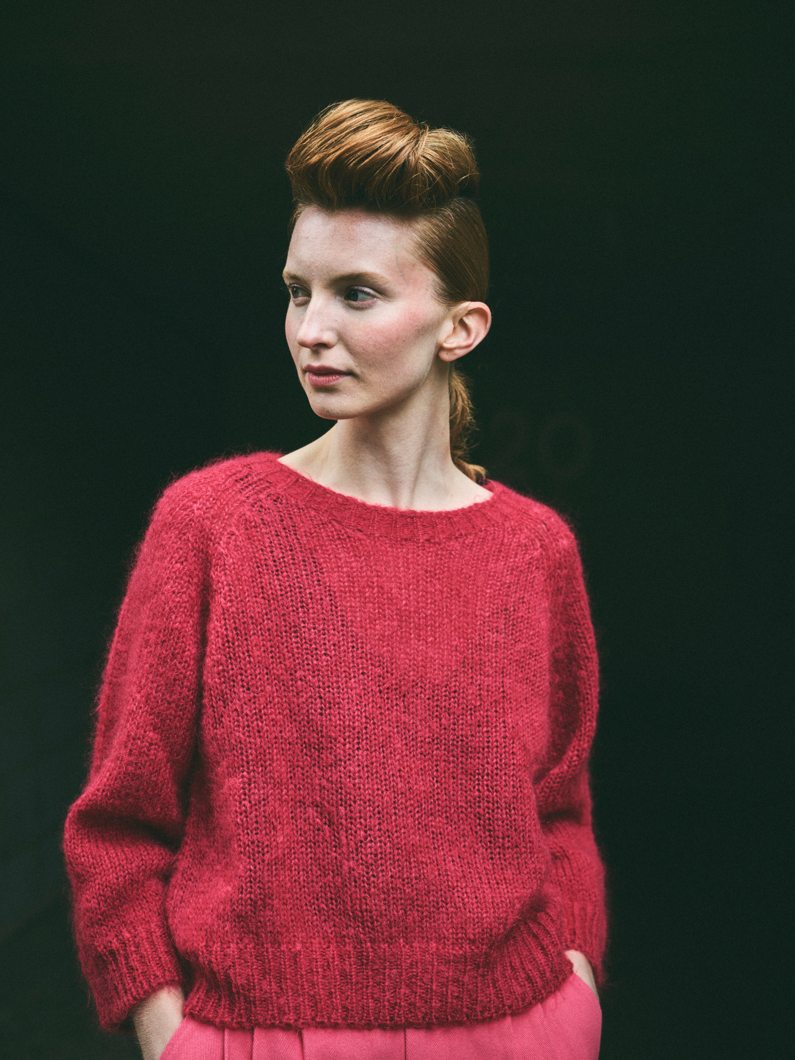 A cropped, bracelet sleeve, round neck red mohair jumper.
