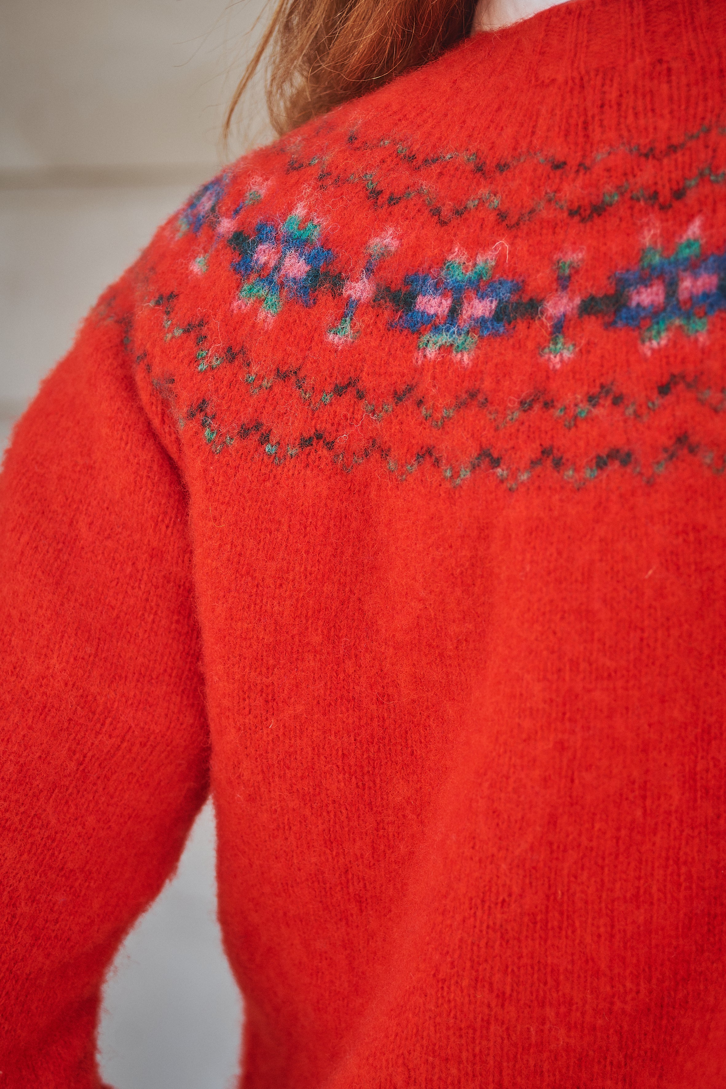 Red knitted sweater with floral pattern on the back