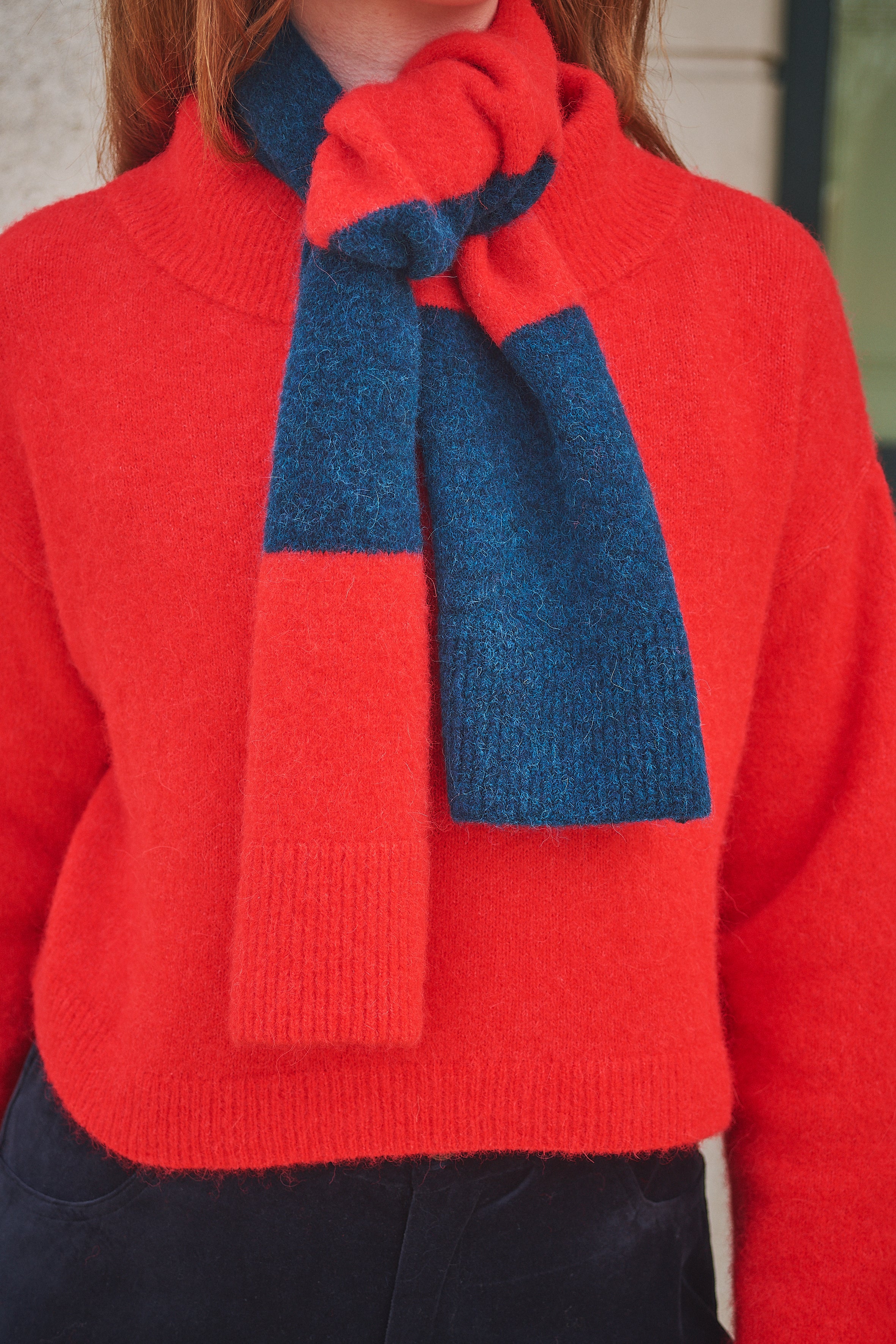 Person wearing a Lowie Red/ Blue Striped scarf