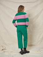 A pair of green pleat front trousers with a tab front opening and back jet pockets.