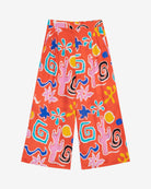 A pair of wide leg cropped trousers with a desert print in vibrant bright orange, featuring front pleats, an elasticated back waist, button and zip on the side, and side pockets.