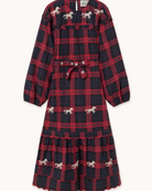 A long-sleeve midi dress with a red and navy blue plaid pattern, decorated with small embroidered white horses, featuring a matching fabric tie belt at the waist.