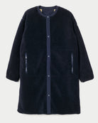 A dark navy blue sherpa fleece coat with a button-up front, ribbed collar, and zippered hand pockets, shown against a light gray background.