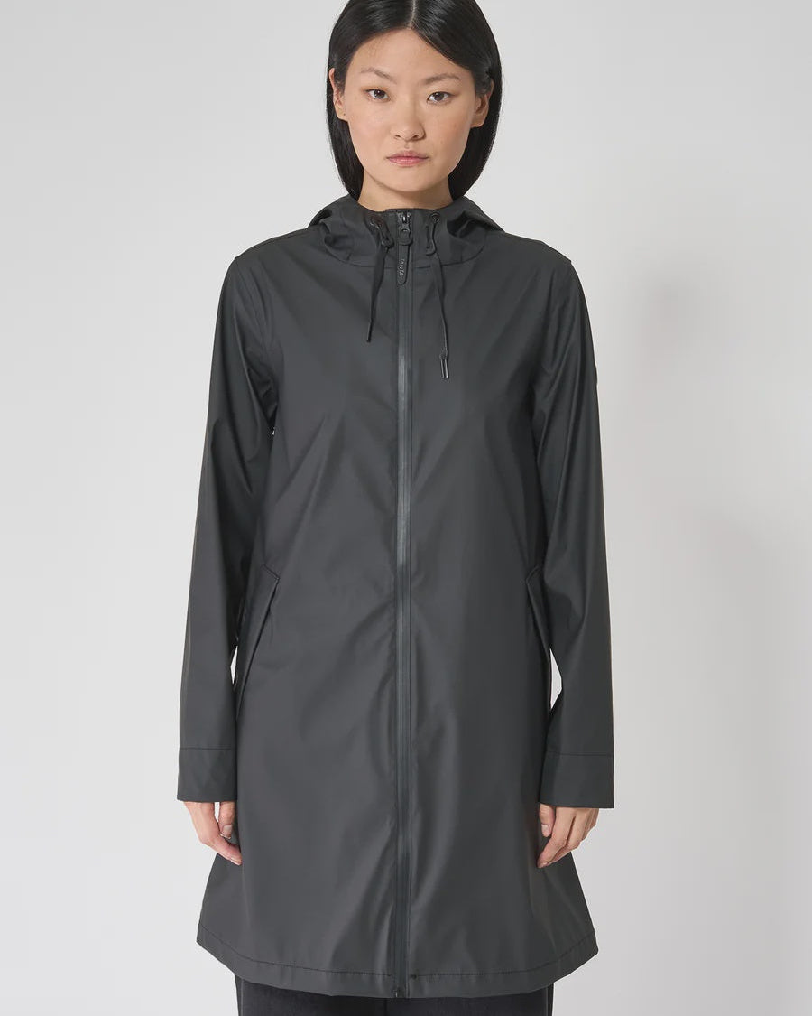 Woman wearing a black raincoat on a white background
