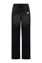 Black jeans with a visible brand label on a white background