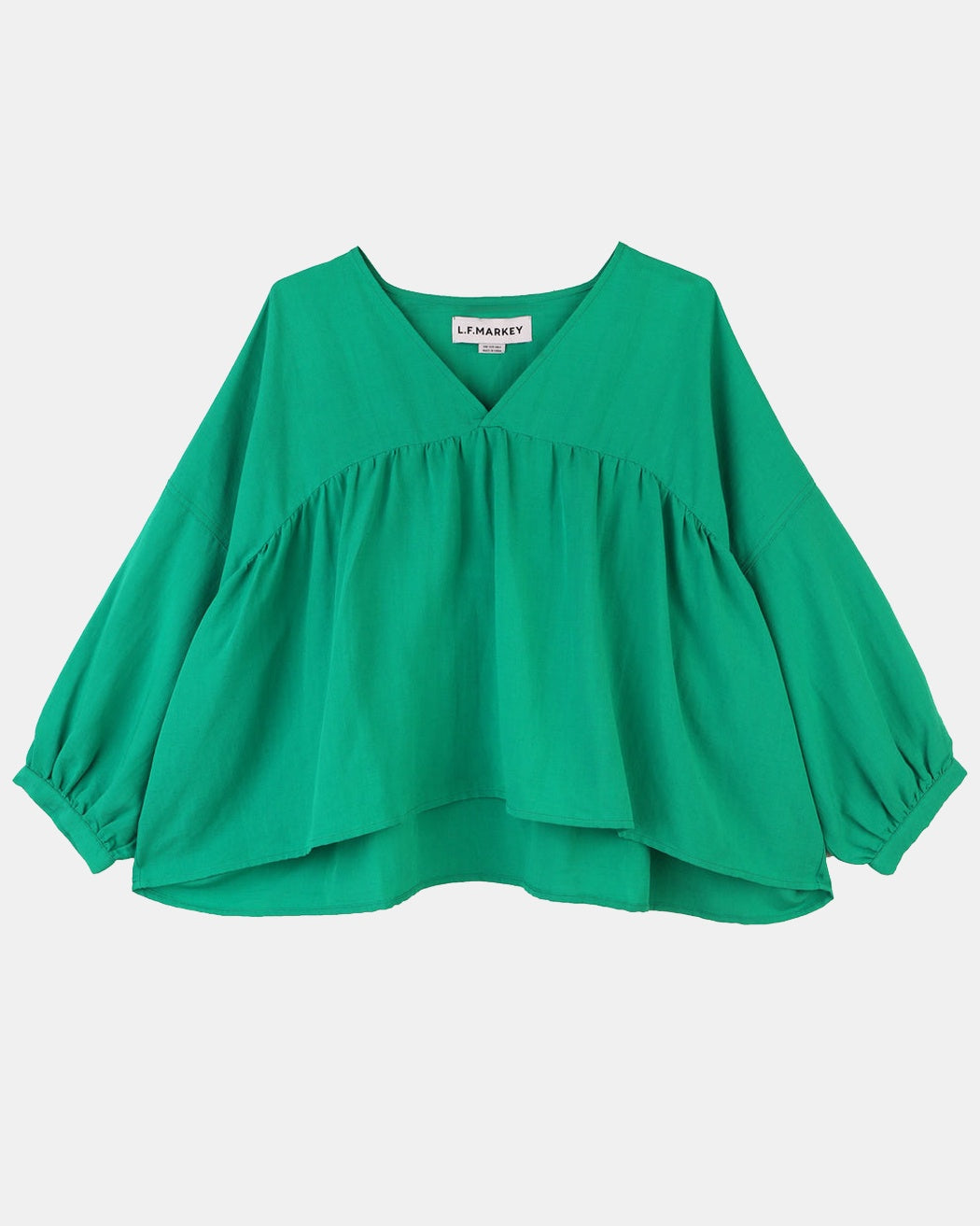 A vibrant grass green, voluminous statement top with a V-neckline and 3/4 length sleeves.