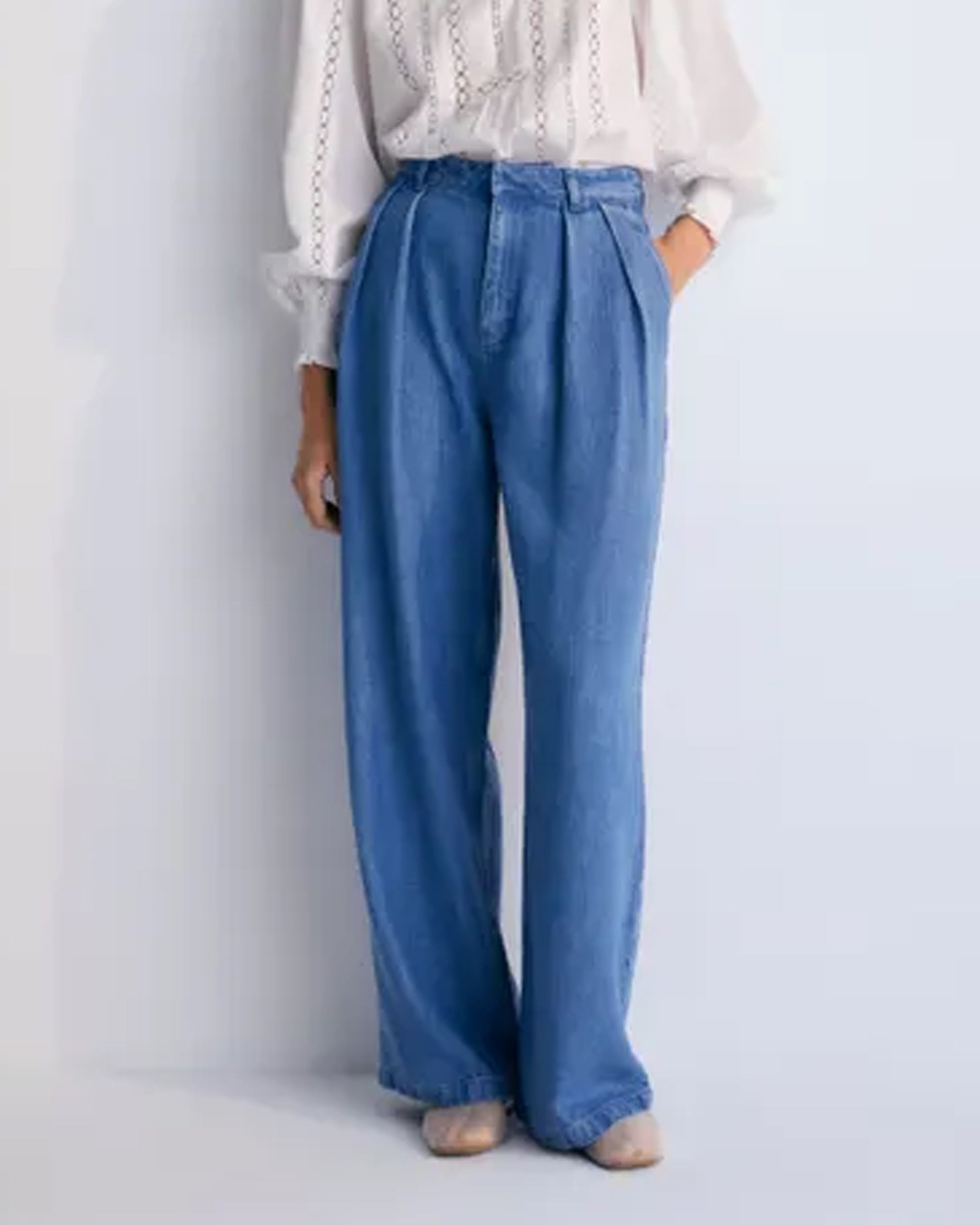 A pair of blue denim jeans with a straight-leg silhouette and back pockets featuring embroidery.