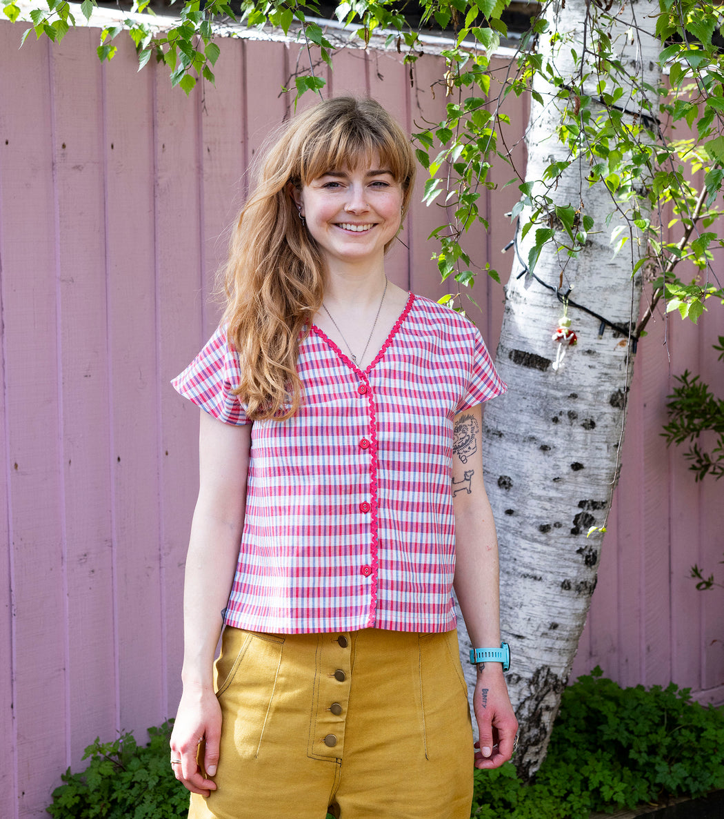 Model wearing Lowie Red & Blue Check Reversible Top styled with jeans.