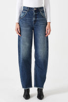 Person wearing blue jeans on a white background