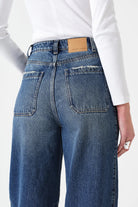 Blue jeans with a white shirt on a white background