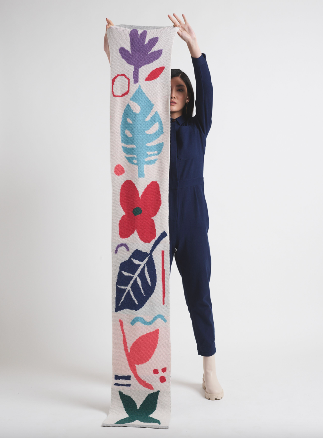 Person holding bright coloured scarf